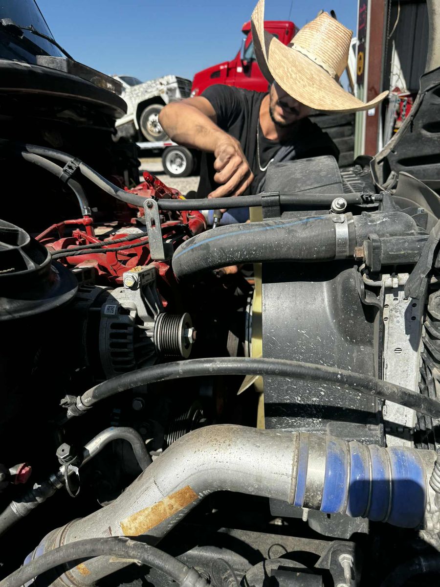 Russell working under the hood of a truck